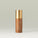 Tropic  Instant Glow perfecting leg serum. See through tube revealing the bronze texture of the product. Subtle leaf design behind the gold text and gold lid.